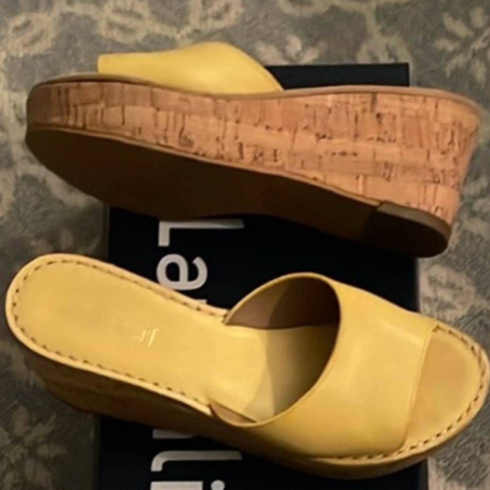 Yellow sandals with cork wedge.